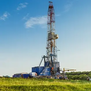 An oil derrick resting on top of a hill